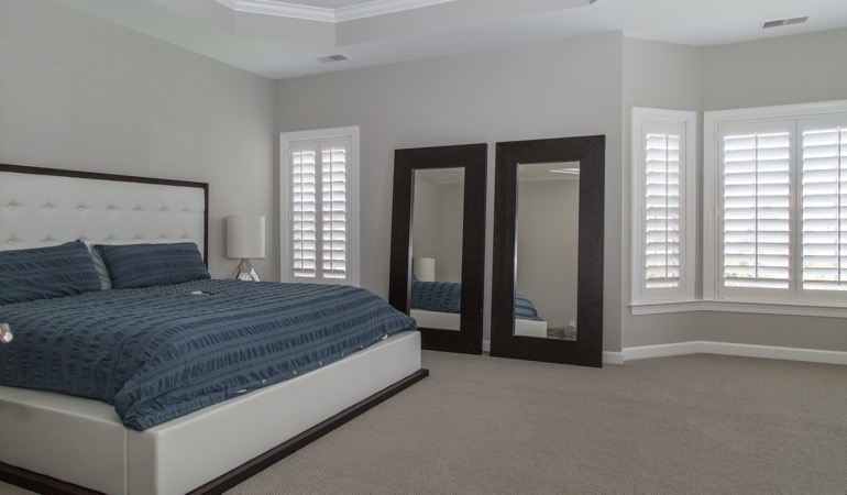 White shutters in a minimalist bedroom in Cincinnati.